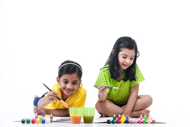 Indian, Asian Cute little girl painting colorful