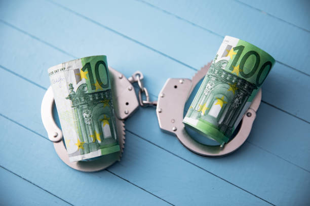 istock money with handcuffs 1248640441