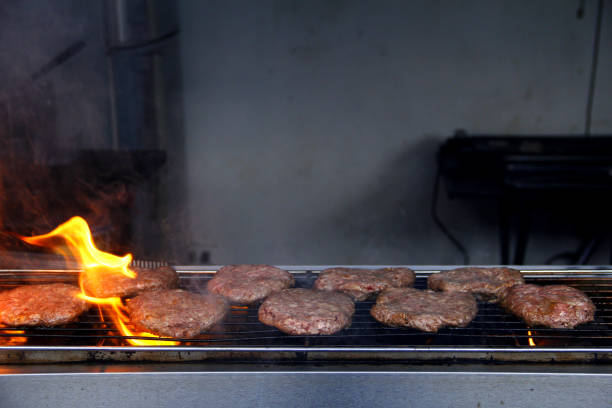 istock Fresh hamburger patties being grilled over fire 1248642848