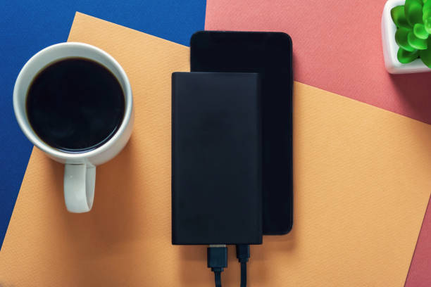 charging Black smart phone with black power bank