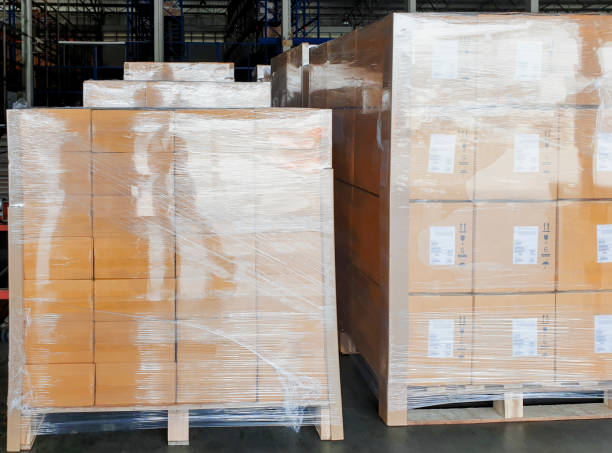 istock Stack of shipment boxes on wooden pallets at interior of warehouse storage. 1248643920
