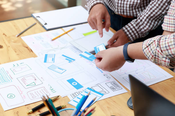 istock Graphic designers work together with UX UI designer planning application template layout framework for mobile phone computer mobile 1248646309