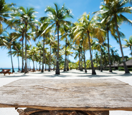 Empty old wood table with tropical paradise beach background