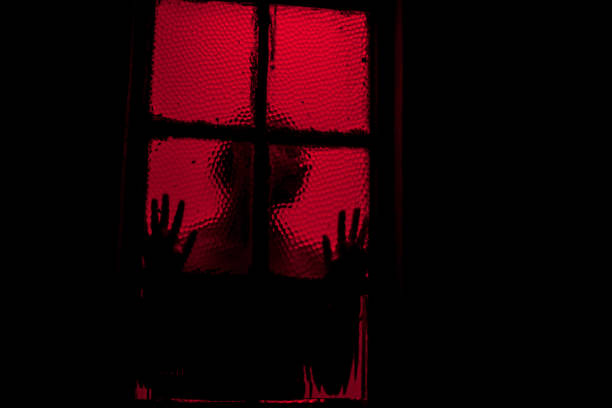 Illuminated Halloween decorations in front of a house.
