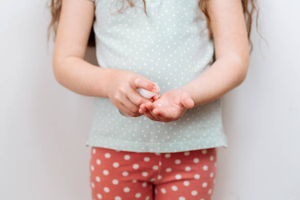 istock The child uses a hand sanitizer 1248653688