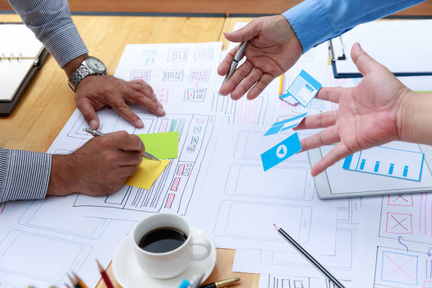 istock Graphic designers work together with UX UI designer planning application template layout framework for mobile phone computer mobile 1248654133