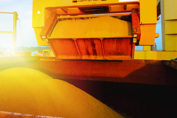 istock Raw sugar bulk loaded into large vessel hole by rotainer for export. Sugar bulk products transport and handling. Agro-industry concept. 1248654144