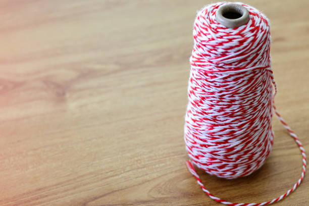 istock red and white rope wrapped around the reel on wood table 1248654221