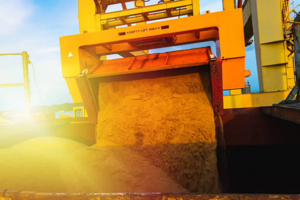 istock Raw sugar bulk loaded into large vessel hole by rotainer for export. Sugar bulk products transport and handling. Agro-industry concept. 1248655109