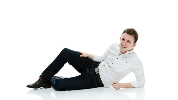 istock Caucasian male lying down in front of white background wearing pants 1248657955