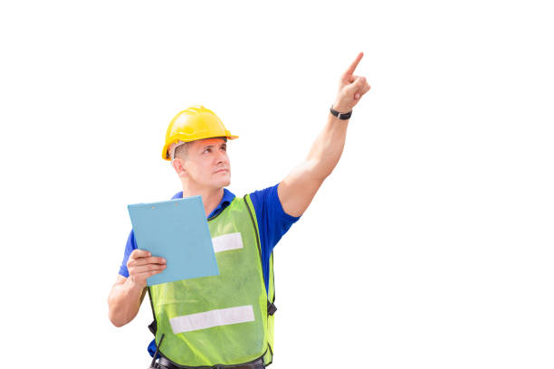istock Engineer man in hard hat holding clipboard checklist smiling and pointing to the sky with clipping path on white background 1248658703