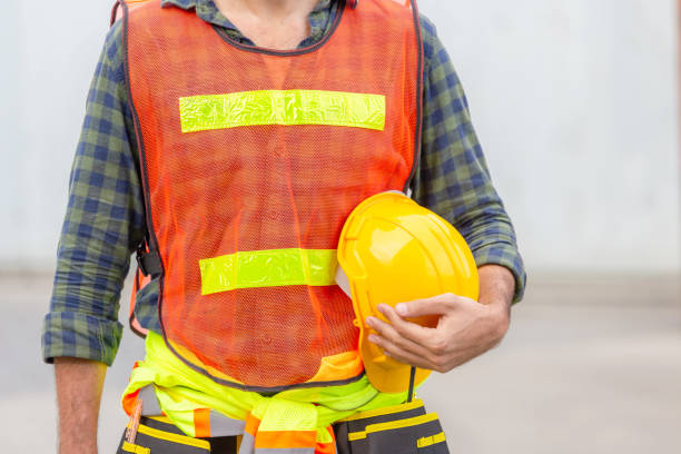 istock Engineer man in safety vest holding hard hat at cargo container 1248659017