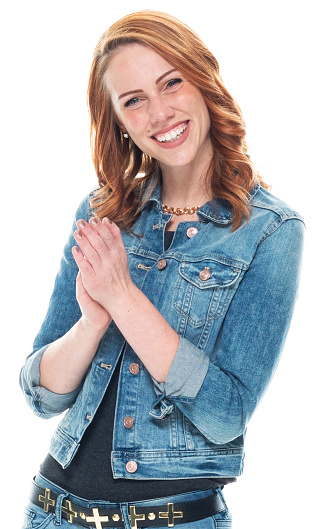 Front view of aged 20-29 years old who is beautiful with redhead caucasian young women standing in front of white background wearing rolled-up sleeves who is excited and applauding
