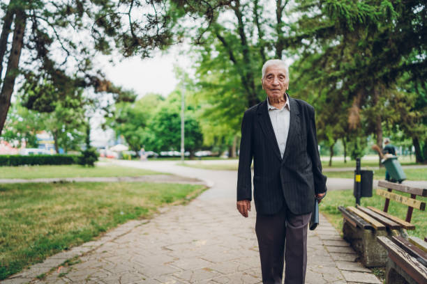 istock Senior man walking in a park 1248661563