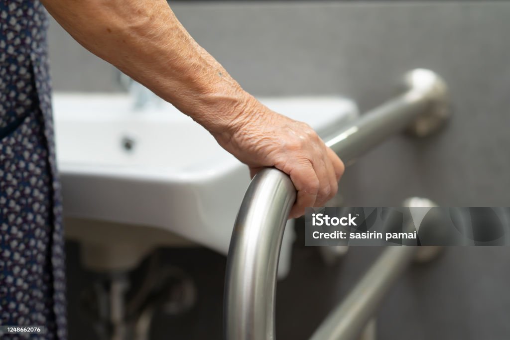 Asian senior or elderly old lady woman patient use toilet bathroom handle security in nursing hospital ward : healthy strong medical concept. Senior Adult Stock Photo