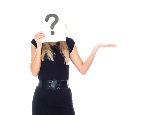 Waist up of aged 20-29 years old who is beautiful with long hair caucasian young women businesswoman standing in front of white background wearing dress who is uncertainty and showing question mark