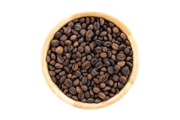 Top view of hand roasted medium coffee beans robusta in bowl isolated on white background