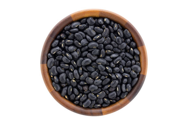 istock Top view of black beans in bowl isolated on white background 1248663123