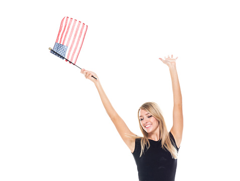 Waist up of aged 20-29 years old who is beautiful with long hair caucasian young women business person standing in front of white background wearing businesswear and greeting and showing patriotism and holding flag