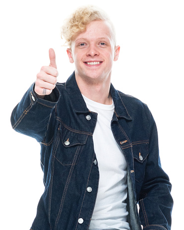 Front view of aged 20-29 years old with blond hair caucasian young male in front of white background wearing shirt who is cheerful and showing thumbs up