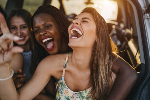 istock Female friends having fun on road trip 1248670412