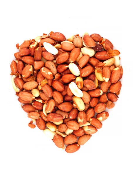 istock Organic unsalted Peanuts in heart symbol isolated on white background 1248673906