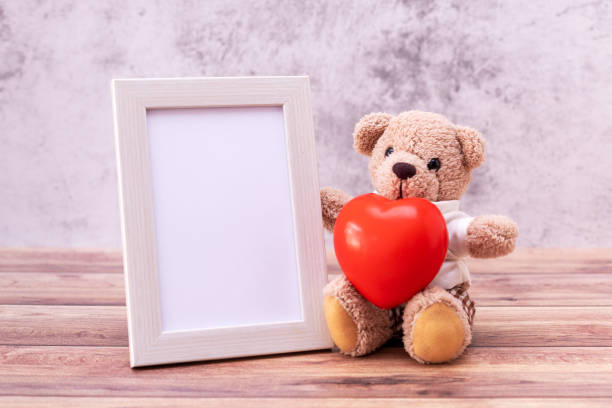 istock teddy bear with Picture frame on table wooden. Valentine's Day celebration 1248674926