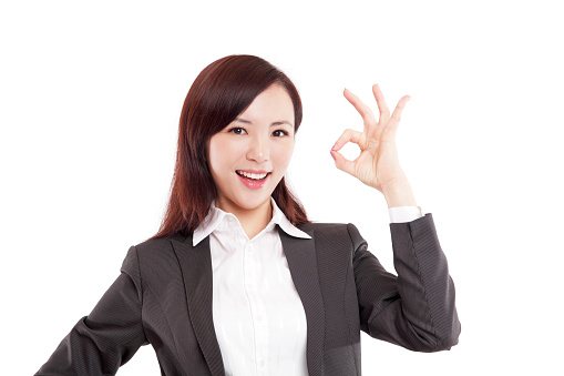 Attractive Young Asian Businesswoman Showing Ok Sign on White Background.