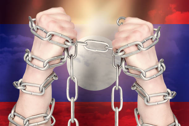 istock Two hands shackled a metal chain on Laos flag. Freedom concept 1248676259