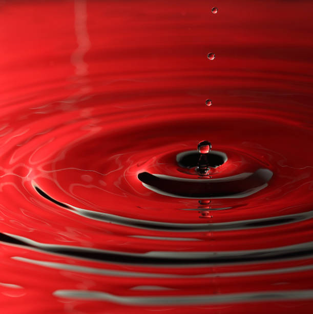 istock Macro of water drop in red color 1248676354