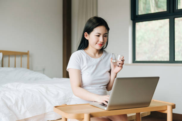 istock Young Asian girl using laptop in bed 1248677266