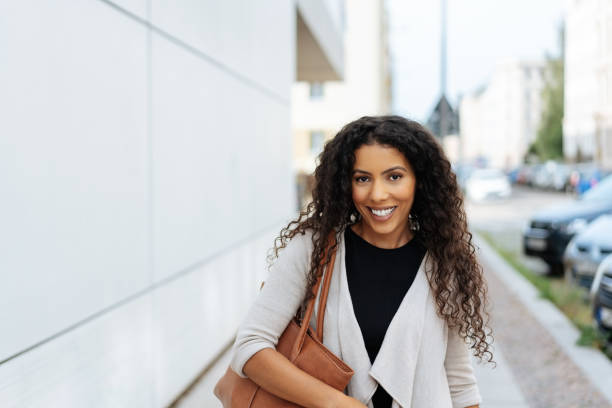 istock Happy friendly African woman walking through town 1248678358