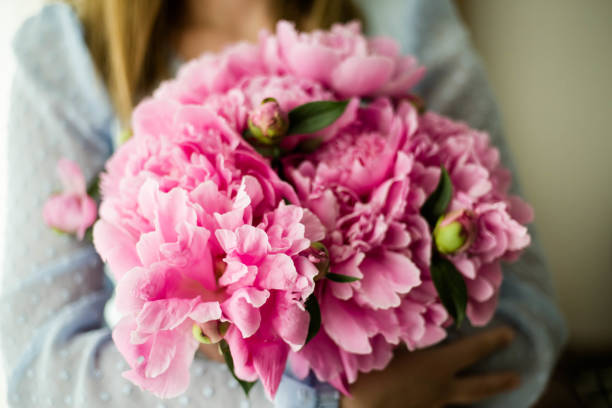 istock Unrecognizable woman holding peonies 1248679223