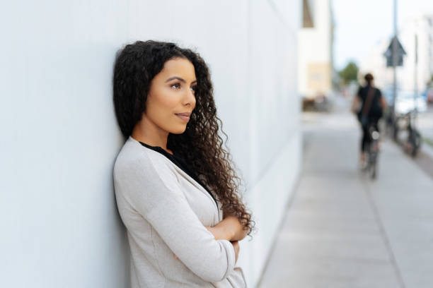 istock Young woman standing waiting in town 1248681032