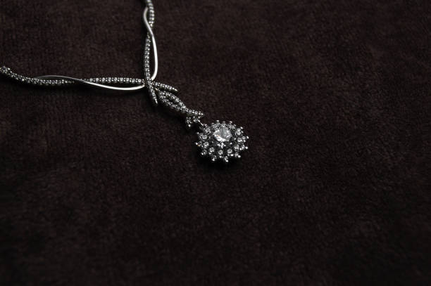istock Elegant silver necklace with precious stones on a black background 1248681532