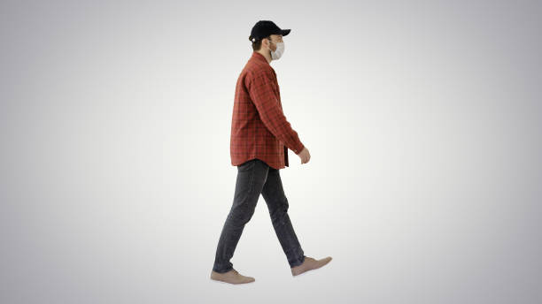 istock American farmer in a cap and medical mask walks along on gradient background 1248682628