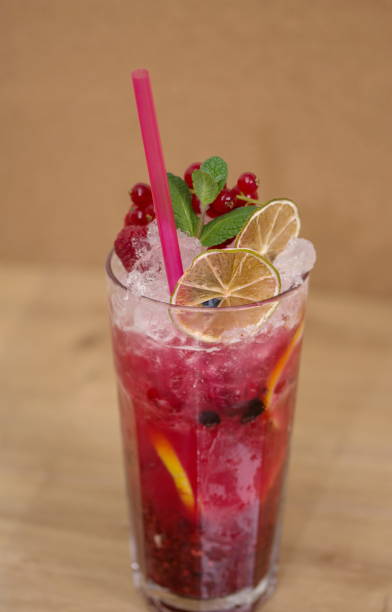 istock Tasty cold fresh drink lemonade with raspberry, mint, ice and lime in glass 1248683315