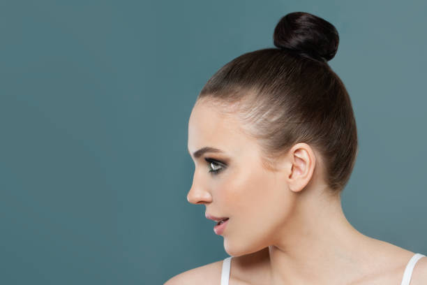 istock Perfect young woman profile on blue background 1248684677