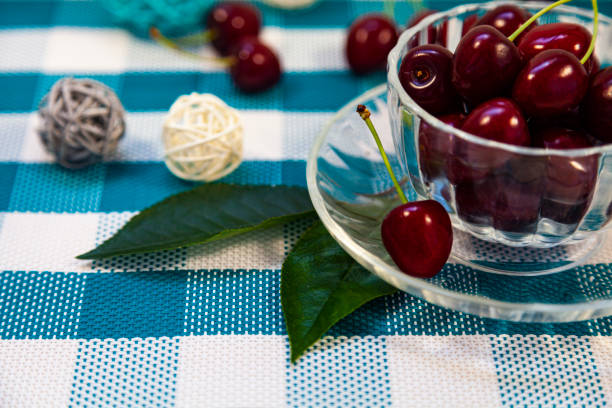 istock Ripe sweet cherries in a cup on a checkered napkin. 1248686620