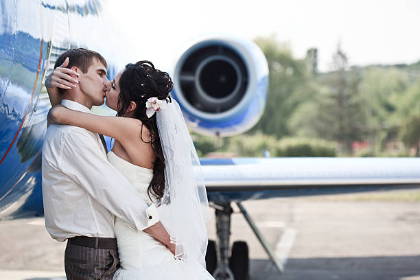 istock Wedding couple fly on honeymoon 124868860