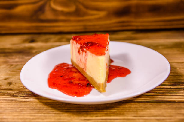 istock White plate with cheesecake New York and raspberry jam on wooden table 1248689650