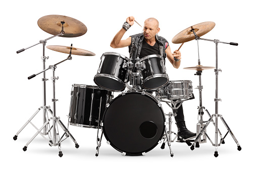 Bald man punkrocker playing a drums isolated on white background