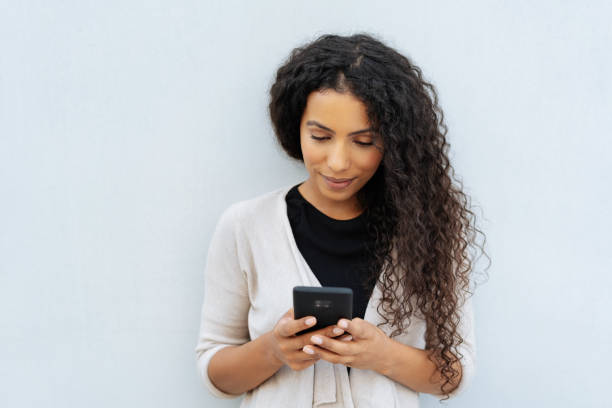 istock Young woman reading an sms or message on a phone 1248689854