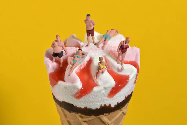 istock Ice Cream In Waffle Cone and Miniature People on Beach 1248689971