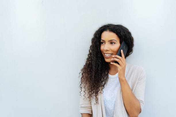 istock Attractive young black woman chatting on a mobile 1248690702