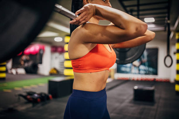 istock Attractive woman training with weights in the gym 1248691624