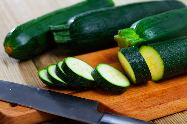 istock Sliced zucchini on wooden table 1248692825