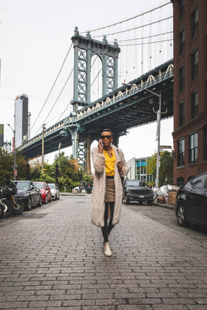 istock Woman in Dumbo - New York talking on mobile 1248693065