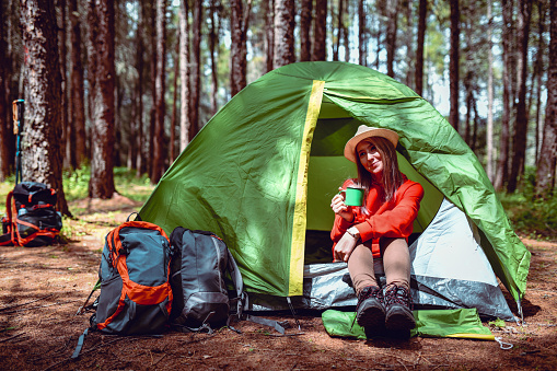 Cute Female Drinking Tea While Sitting In Tent