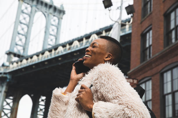 istock Woman in Dumbo - New York talking on mobile 1248693655